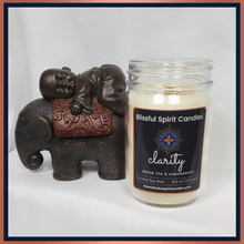 Load image into Gallery viewer, coconut soy candle with wooden wick 8.5 oz mason jar with black lid - text candle name Clarity white prop background, green tea and lemongrass fragrance

