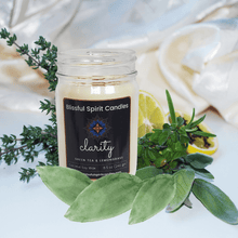 Load image into Gallery viewer, coconut soy candle with wooden wick 8.5 oz mason jar with black lid - text candle name Clarity white prop background, green tea and lemongrass fragrance
