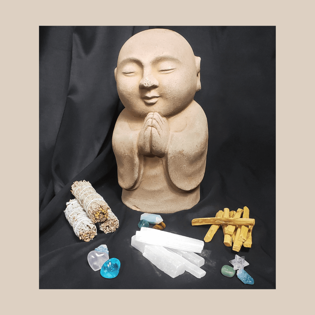 Energy Clearing Bundle buddha with sage Palo Santo sticks, selenite and crystals black background.