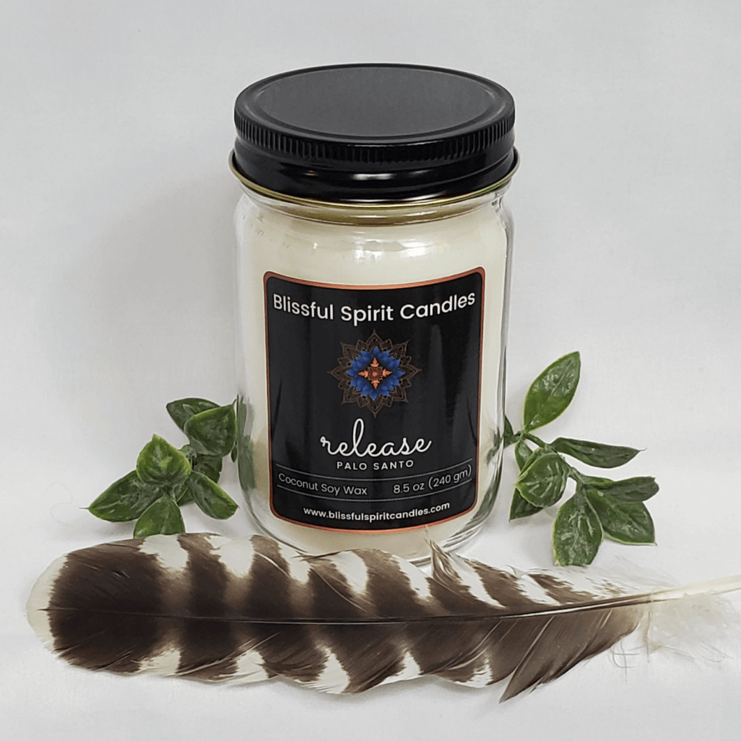 coconut soy candle with wooden wick 8.5 oz mason jar with black lid - text candle name release, white prop background, Palo Santo fragrance