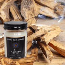 Load image into Gallery viewer, coconut soy candle with wooden wick 8.5 oz mason jar with black lid - text candle name release, white prop background, Palo Santo fragrance
